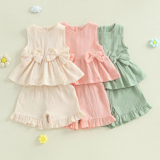2024-12-24 Lioraitiin Toddler Baby Girl Summer Clothes Solid Color Bow Round Neck Tank Tops + Elastic Waist Ruffled Shorts Set